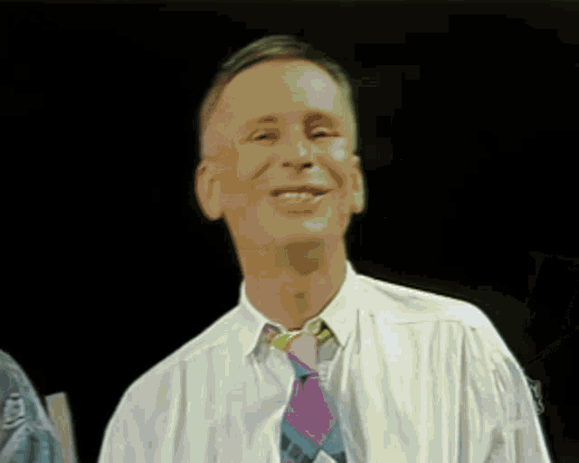 a man in a white shirt and tie is smiling in front of a black background that says dziekuje
