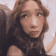 a close up of a woman 's face making a funny face .
