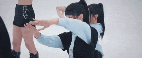 a couple of girls are standing next to each other on a white background .