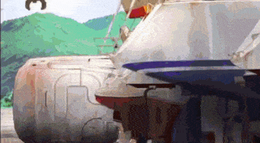 a boat is sitting in the water with mountains in the background