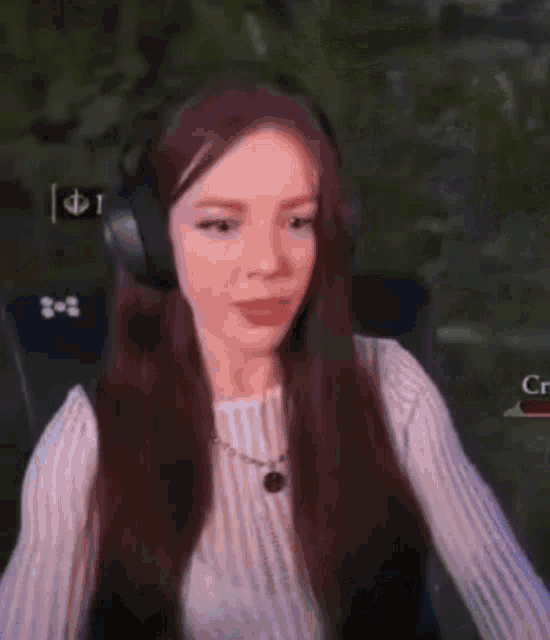 a woman wearing headphones is screaming while playing a game