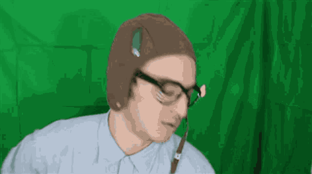 a man wearing a hat and glasses is making a funny face