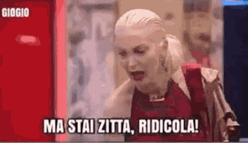 a woman is sitting in front of a computer screen and saying `` ma stai zitta , ridicola ! ''