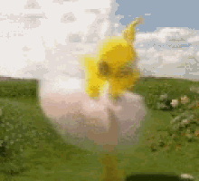 a windmill is spinning in a field of grass .