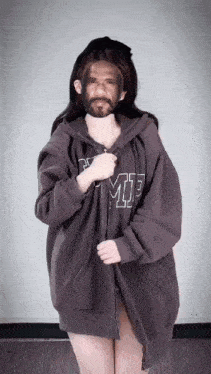 a woman wearing a hoodie that says ' mp ' on the front