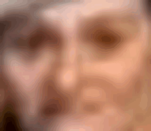 a close up of a woman 's face with a blurry background