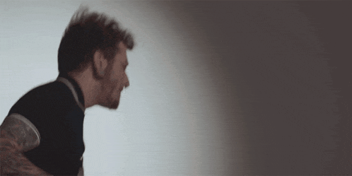 a man 's head is visible in a blurry photo with a white background