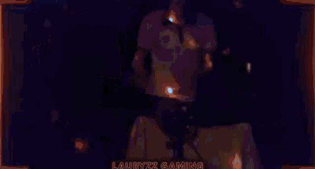 a man is playing a video game in a dark room with the words lauryzz gaming on the bottom .
