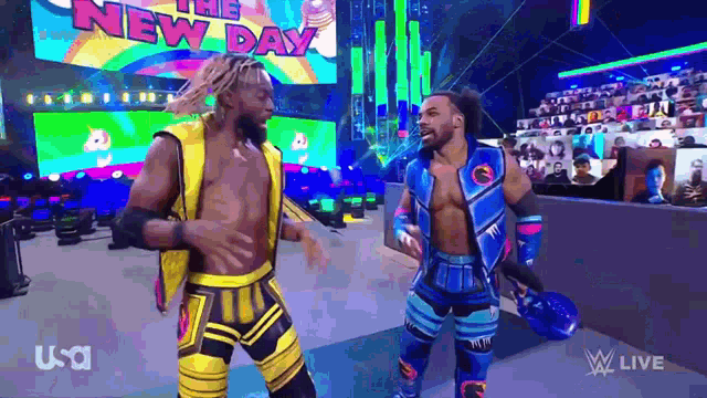 a couple of men are standing next to each other on a stage .