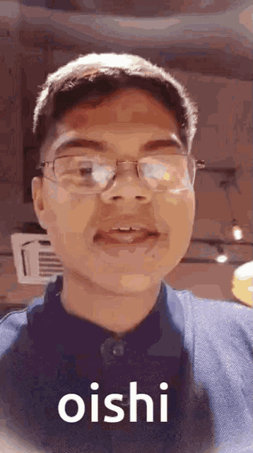 a young man wearing glasses is making a funny face .