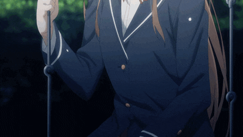 a girl in a blue school uniform is sitting on a swing