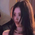 a woman with long black hair is looking at the camera .