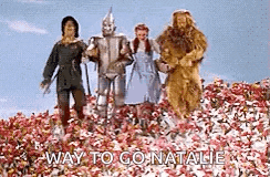 a group of people standing in a field of flowers with the words `` way to go natalie '' .