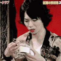 a man is holding a spoon in his hand in front of a red background with chinese writing on it .