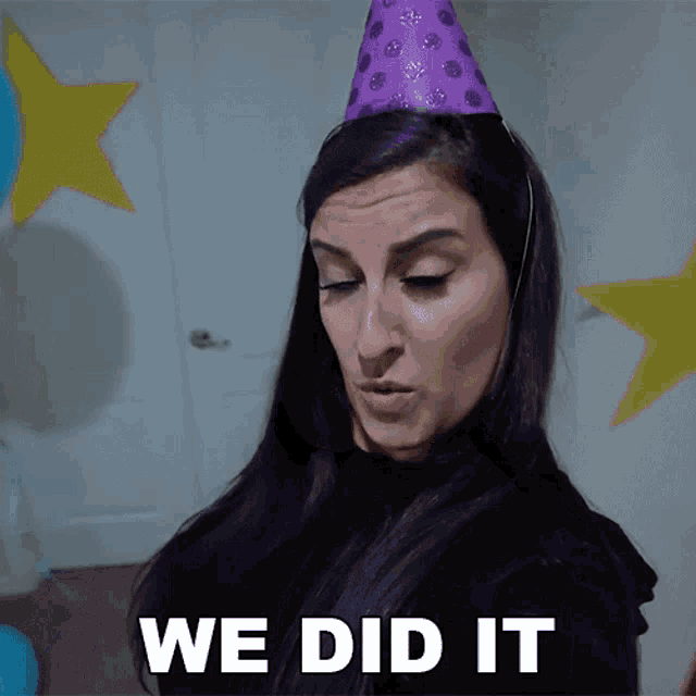 a woman with purple hair wearing a purple party hat says we did it