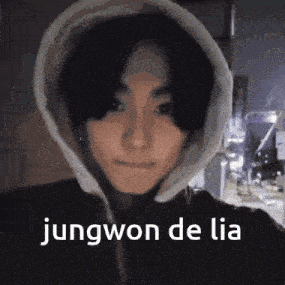 a close up of a person wearing a hoodie with the words jungwon de lia written on it .