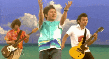 a group of men are playing guitars and one of them is wearing a blue shirt that says same