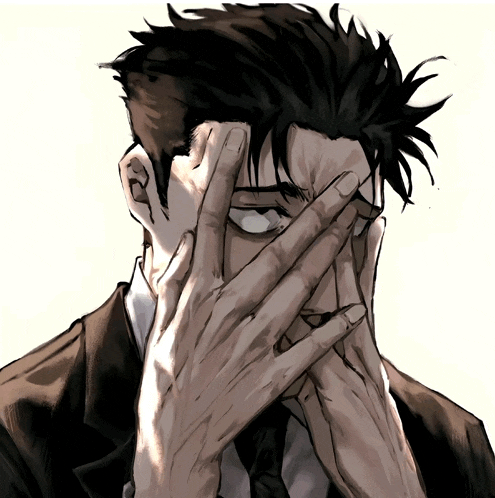 a man in a suit and tie covering his face with his hand