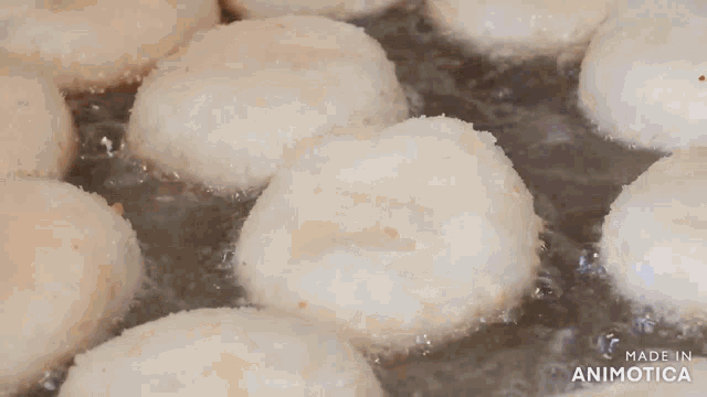 a pan filled with fried doughnuts is made in animatica