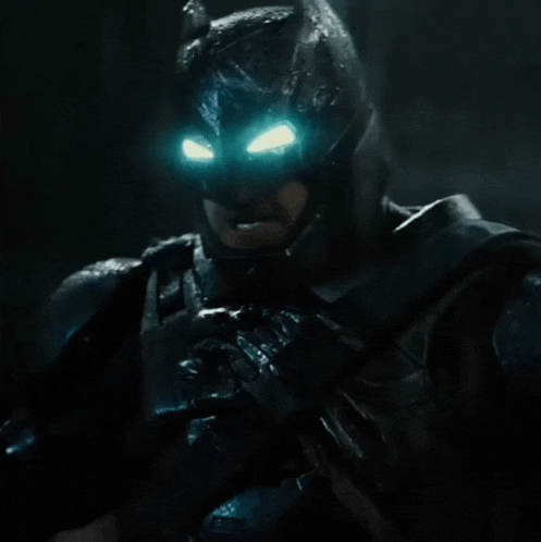 a close up of batman 's face with blue eyes