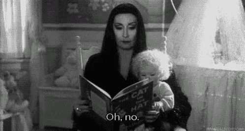 a woman is reading a book to a baby while holding a doll .