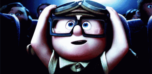 a cartoon character wearing goggles and glasses is sitting in a theater watching a movie
