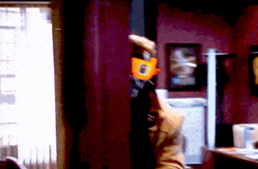 a person is holding a toy gun with the letter f on the handle