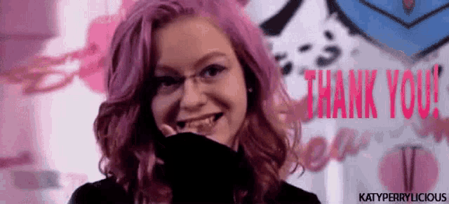 a woman with pink hair says thank you in red letters
