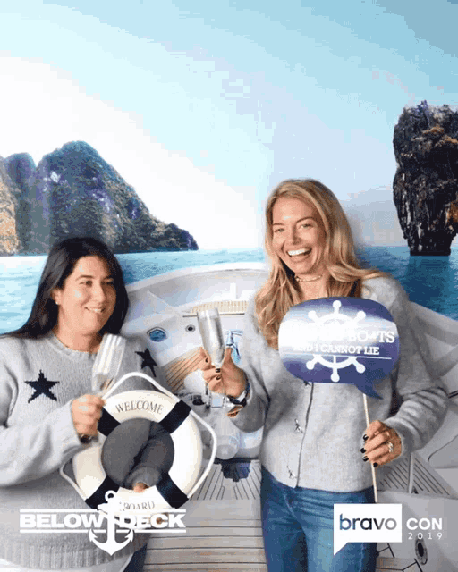 two women posing for a photo with a sign that says below deck on it