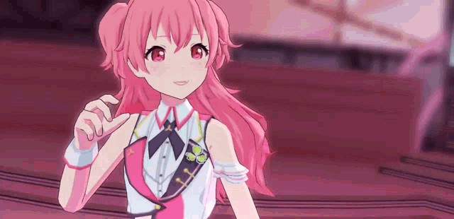 a pink haired anime girl is standing on a stage .