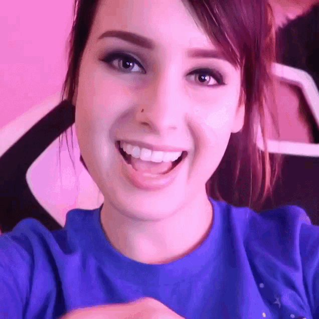 a close up of a woman 's face with a blue shirt on