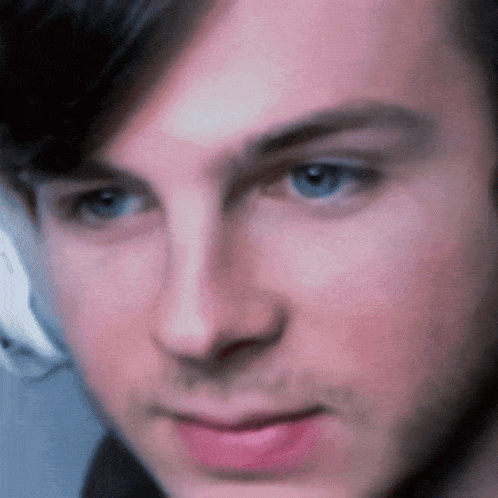 a close up of a man 's face with a blurred background