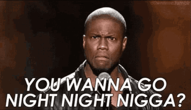 a man is standing in front of a microphone and saying you wanna go night night nigga