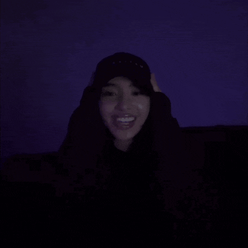 a person wearing a hat is making a funny face