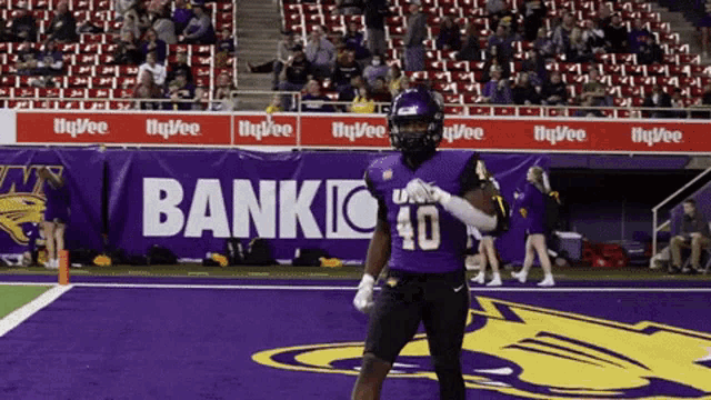 a football player wearing a purple jersey with the number 10