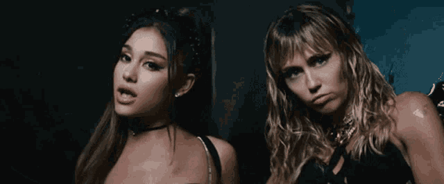 ariana grande and miley cyrus are posing for a photo together
