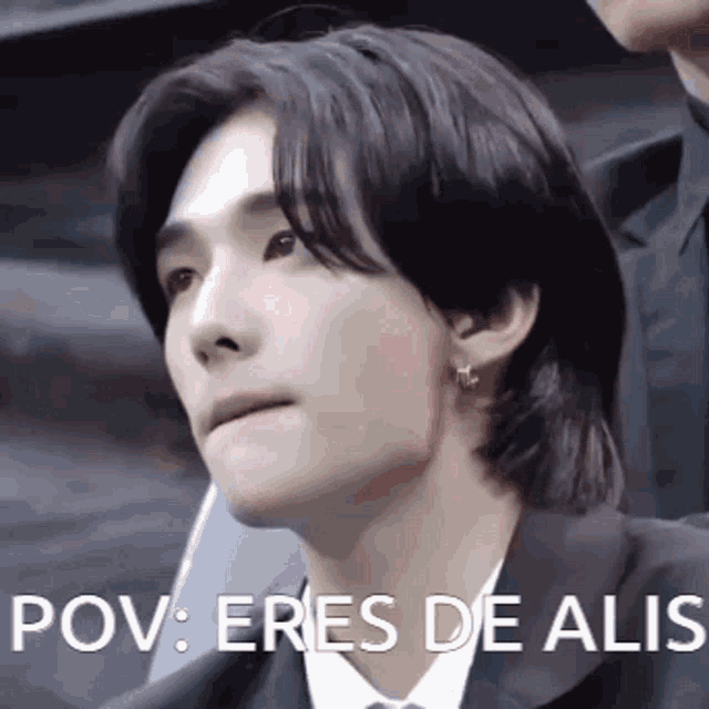 a close up of a man 's face with the words pov : eres de alis written on it .
