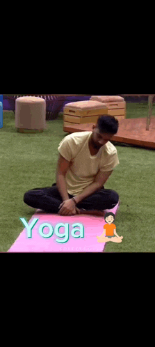 a man is sitting on a yoga mat with the word yoga written above him