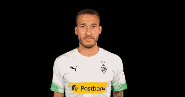 a man wearing a white shirt with a yellow stripe that says postbank