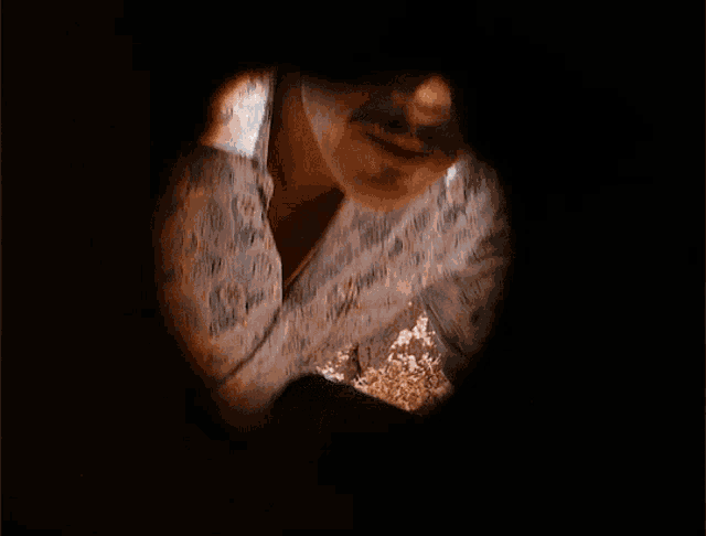 a man with a mustache is looking through a hole