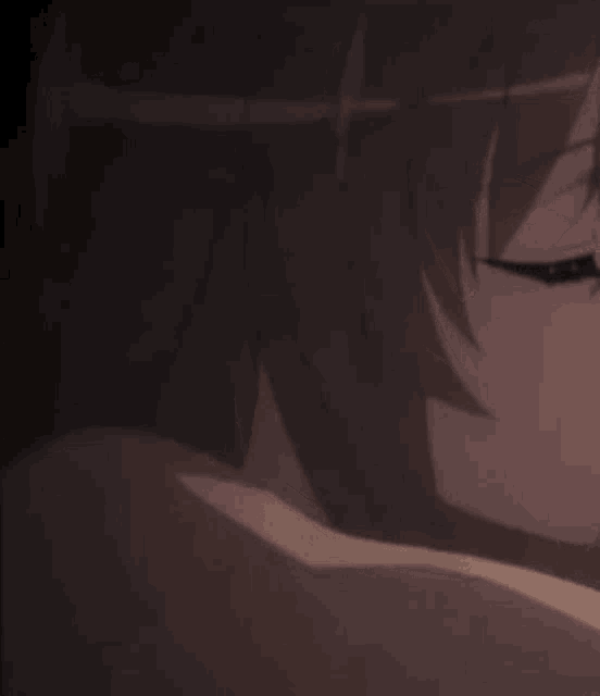a close up of a person 's face in a dark room with a blurred background .