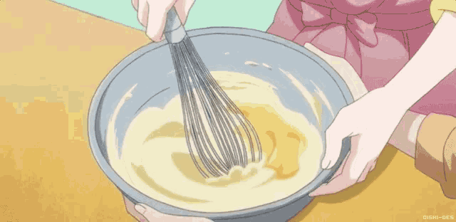 a person is whisking something in a bowl with a whisk