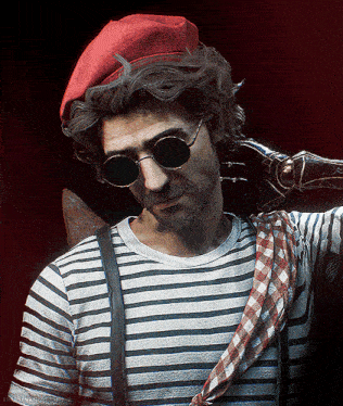 a man wearing a red beret and sunglasses has a striped shirt and suspenders around his waist