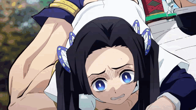 a girl with butterfly ear clips is being held by a man