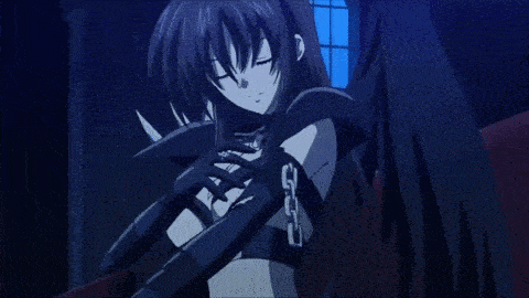 a girl in a black latex outfit is standing in a dark room .