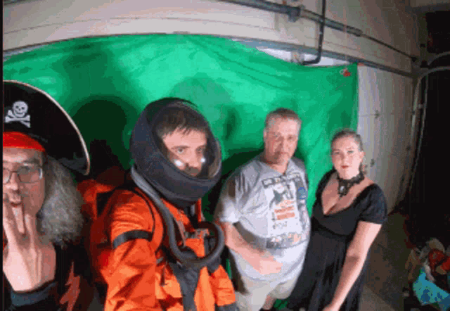 a group of people posing for a picture with one wearing a space suit