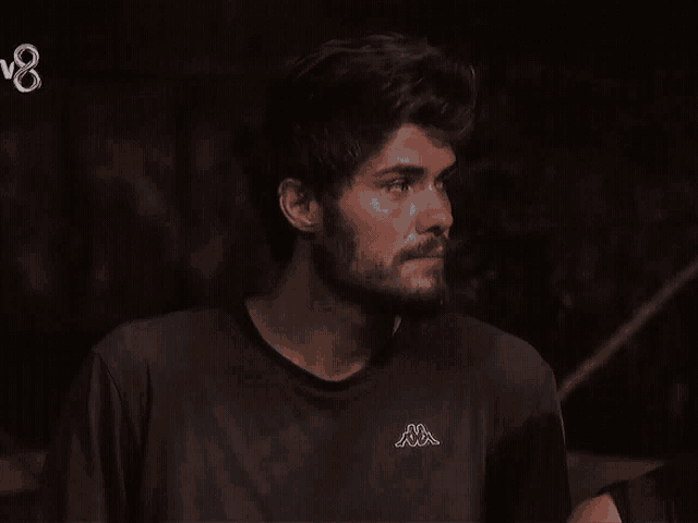 a man with a beard wears a kappa t-shirt