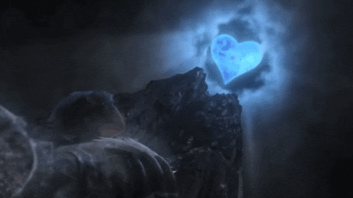 a person is looking at a blue heart shaped object