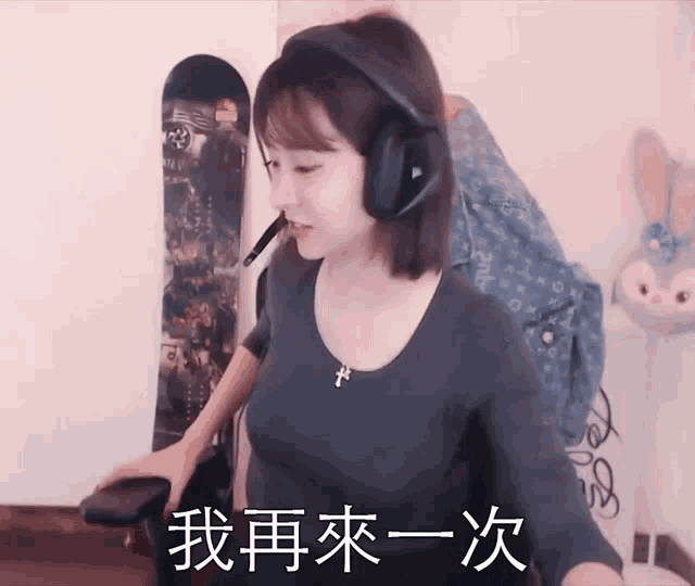 a woman wearing headphones holds a remote control in her hand