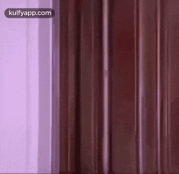 a close up of a purple and brown striped wall .